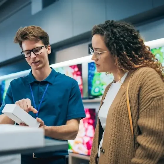 Retail worker explaining product to customer