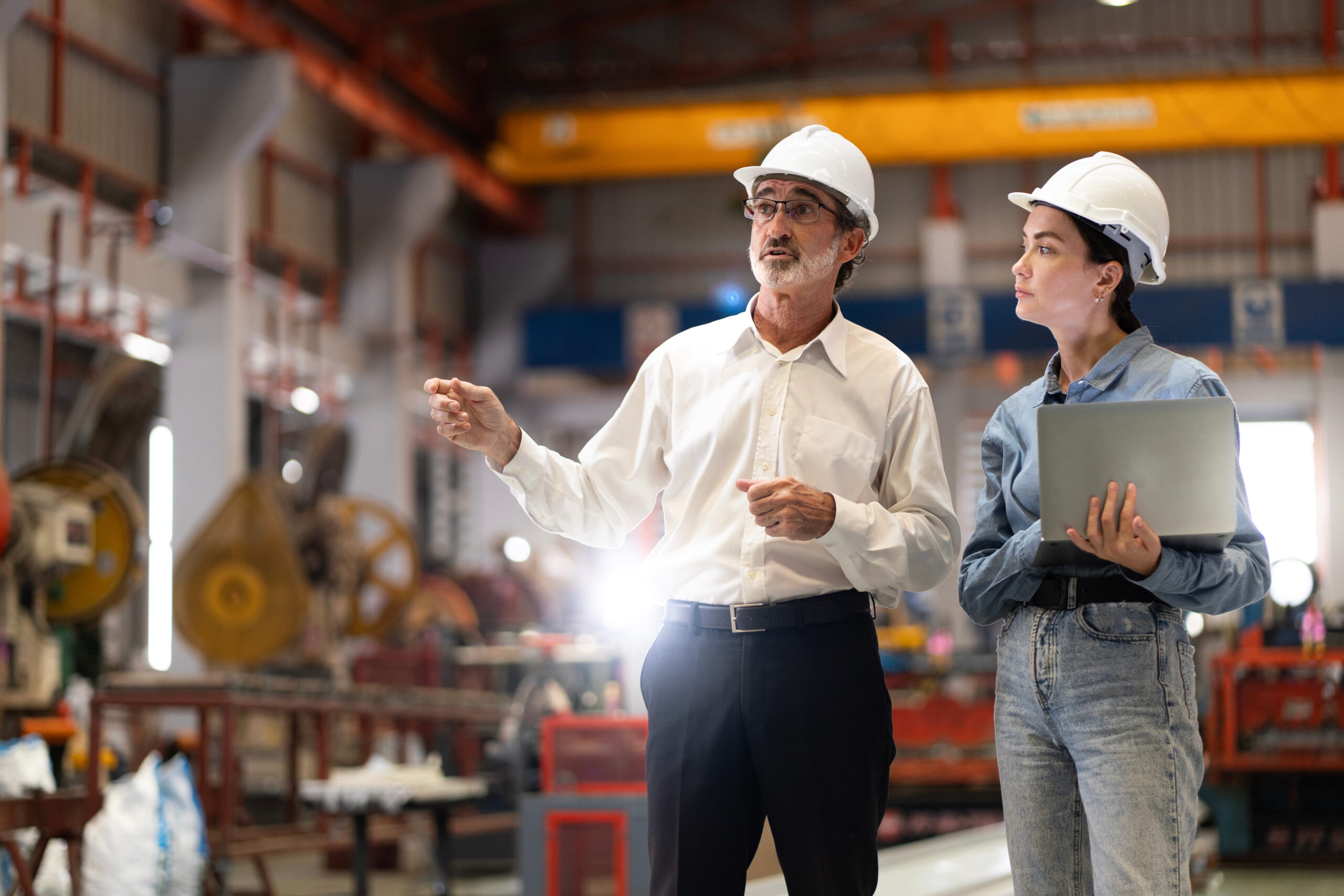 A manager in a manufacturing factory mentors a worker on leadership